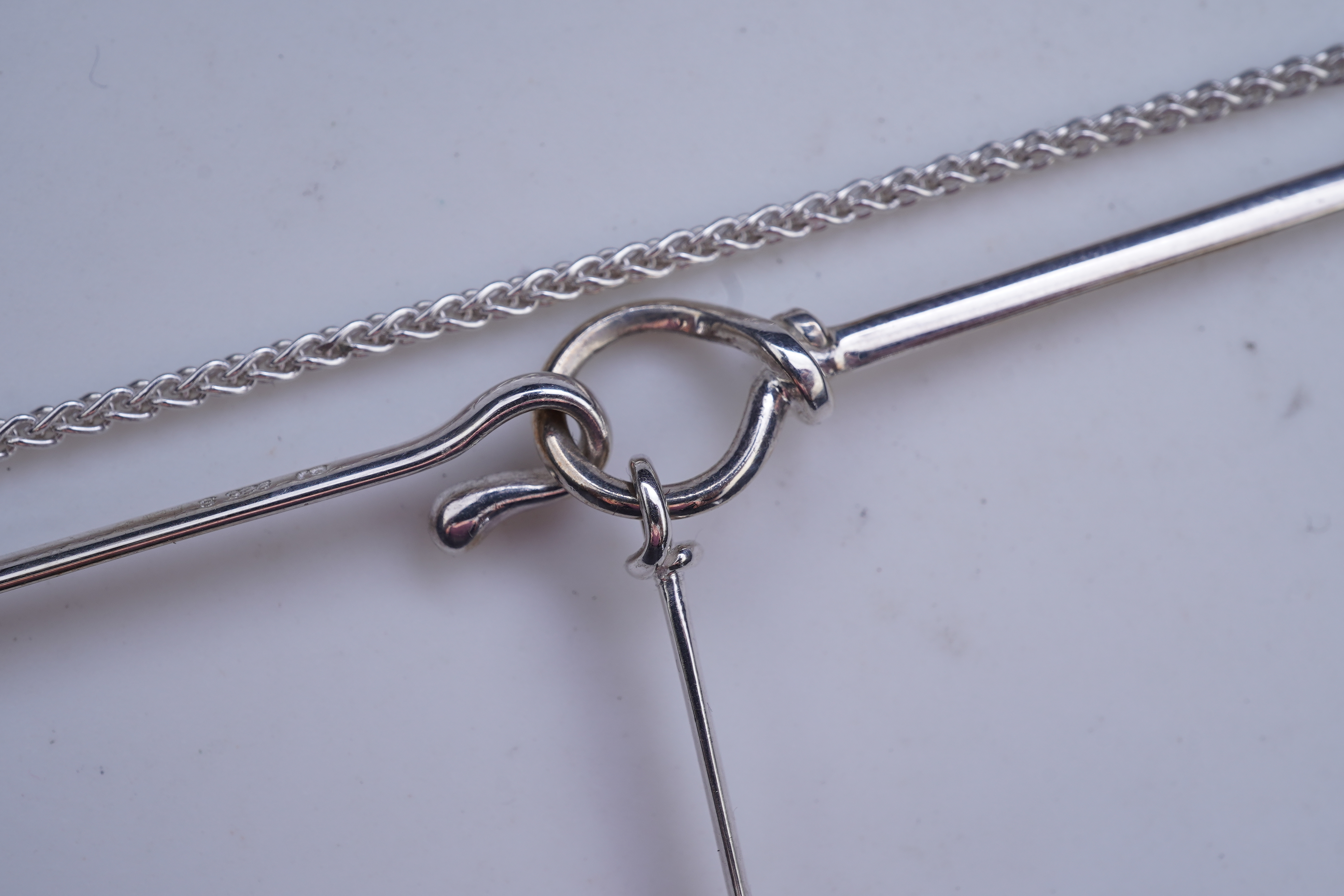 Georg Jensen, a blue topaz necklace, centring on a hook clasp suspending an oval blue topaz pendant, pendant length 5.5cm, necklace length 43cm, stamped GJ for Georg Jensen, 925S and European convention assay marks for s